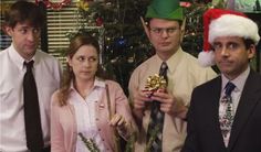 three people standing next to each other in front of a christmas tree