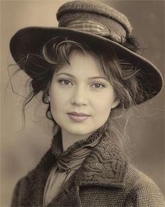 an old photo of a woman wearing a hat