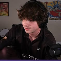 a young man wearing headphones sitting down