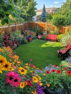 a garden with lots of colorful flowers and plants in the center, surrounded by wooden fence