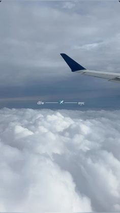 an airplane wing flying above the clouds with two arrows pointing in opposite directions on it