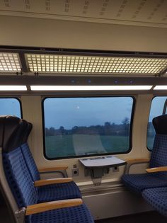 the inside of a train with blue seats