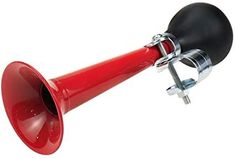 a red and black megaphone attached to a metal hook on a white background with clippings