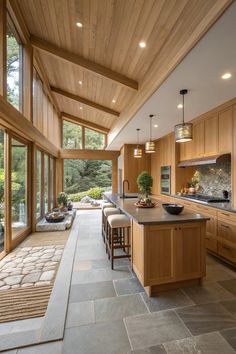 a large kitchen with wooden cabinets and counter tops next to an open floor plan area