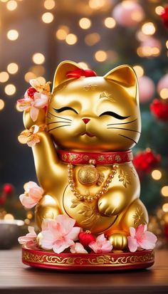 a gold cat figurine sitting on top of a table