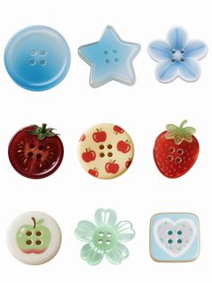various buttons with different designs on them and some flowers in the middle one has a star