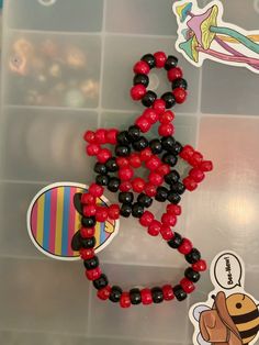 the beaded bracelet is decorated with black, red and yellow beads on it's side