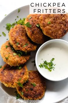 chicken fritters on a white plate with ranch dip and cilantro garnish