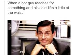 a man in a suit sitting at a desk with his chin resting on his hand