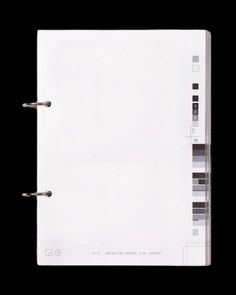 an open white binder on a black background