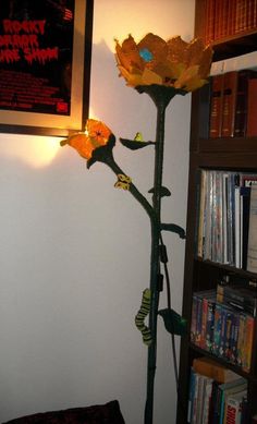 there is a lamp that has been placed on the wall next to a book shelf