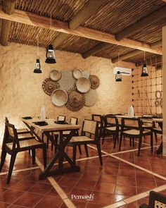 a restaurant with wooden tables and chairs in front of a wall hanging wicker baskets