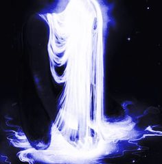 a woman with long white hair sitting in the dark