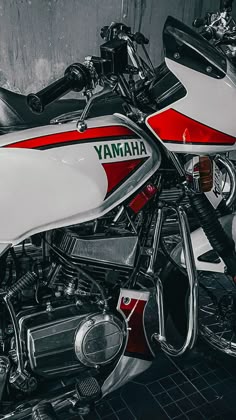 a red and white yamaha motorcycle parked in a garage