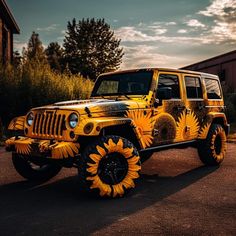 a yellow jeep with sunflowers painted on it's front and rear tires