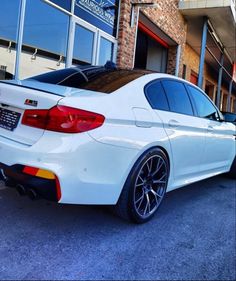 a white car parked in front of a building