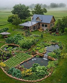an aerial view of a farm house with a pond and vegetable garden in the foreground