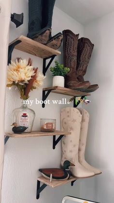 boots and flowers are sitting on the shelves in this bathroom, with text that reads my boot wall
