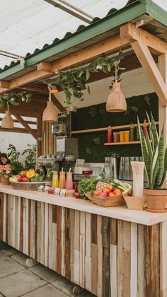 an outdoor bar with fruits and vegetables on it