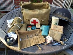 an assortment of medical items sitting on top of a wooden table next to a bag