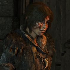 a woman in a fur coat standing next to a door with blood on her face