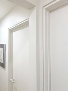 an open door leading to another room with pictures on the wall