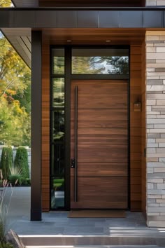 the front door to a modern home with wood and glass