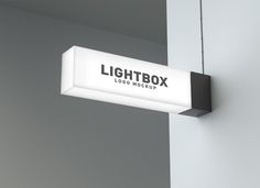 a lightbox sign hanging from the side of a wall