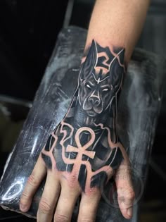 a person with a dog tattoo on their hand