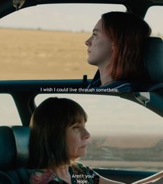 two women sitting in the back seat of a car, one with her head turned to the side