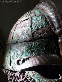 an old helmet is on display in a museum