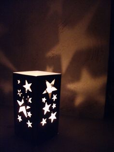 a lit up paper lantern with stars on it