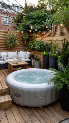 a hot tub sitting on top of a wooden deck next to a couch and table