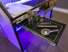 an open cabinet with various kitchen utensils in it