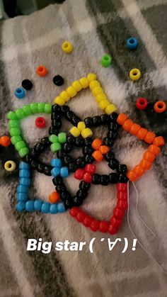 some beads are laying on top of a blanket with the words, big star v