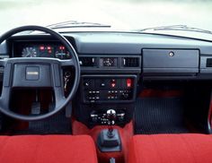 the interior of a car with red seats and dashboard