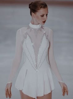 a woman in a short white dress is standing