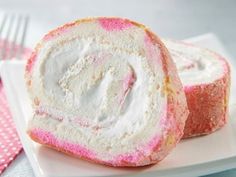 two pieces of bread with white frosting and pink sprinkles on a plate