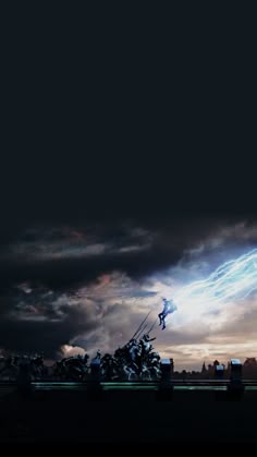 a man flying through the air while riding a skateboard in front of a sky filled with clouds