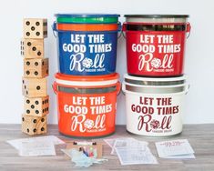 four buckets with dice and wooden blocks next to them