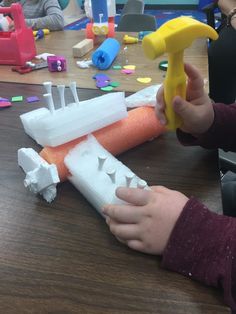 a child is playing with construction toys on the table