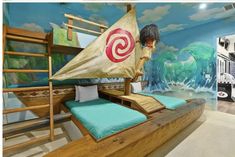 a child's bedroom with a boat bed in the middle and a mural on the wall