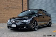 a black car parked in front of a building
