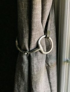 a curtain with a metal ring hanging from it's side