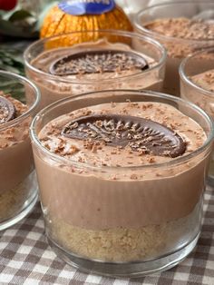several desserts in small glass dishes on a table