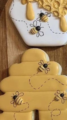 two cookies decorated with bees and honeycombs