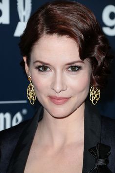 a close up of a person wearing earrings