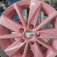 a pink car wheel is shown in this close up photo, with the spokes missing