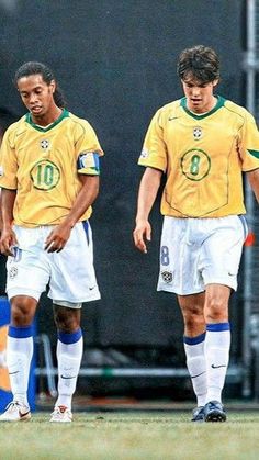 two soccer players standing next to each other