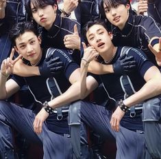 the group of young men are posing for a photo with their hands in the air